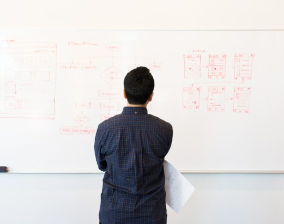 man standing near whiteboard
