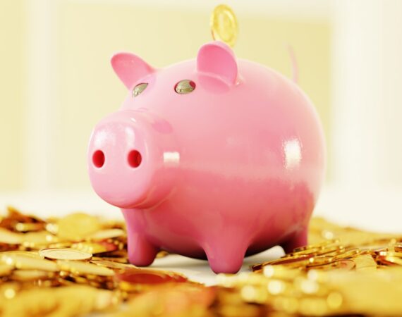 pink pig coin bank on brown wooden table