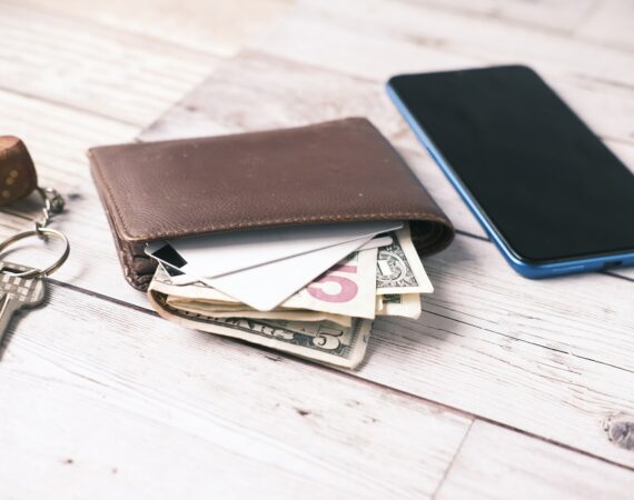 black leather bifold wallet on white table