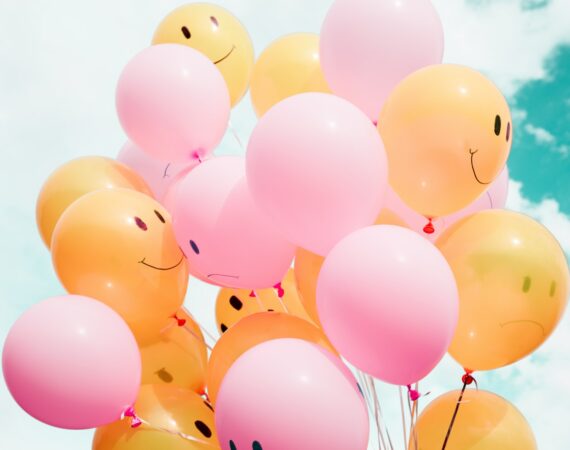 low-angle photo of pink and orange balloons